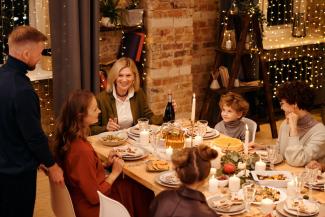 Family sitting at a table together for a holiday dinner