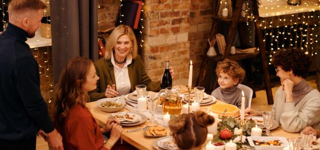 Family sitting at a table together for a holiday dinner